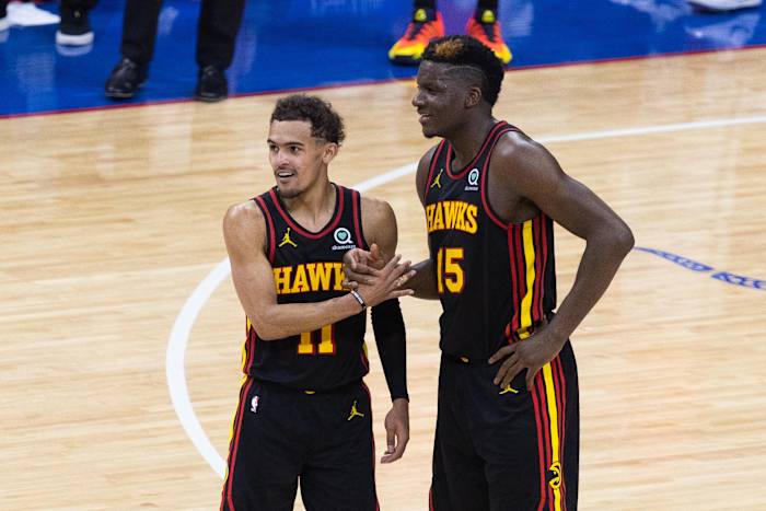 Atlanta Hawks guard Trae Young shakes hands with center Clint Capela